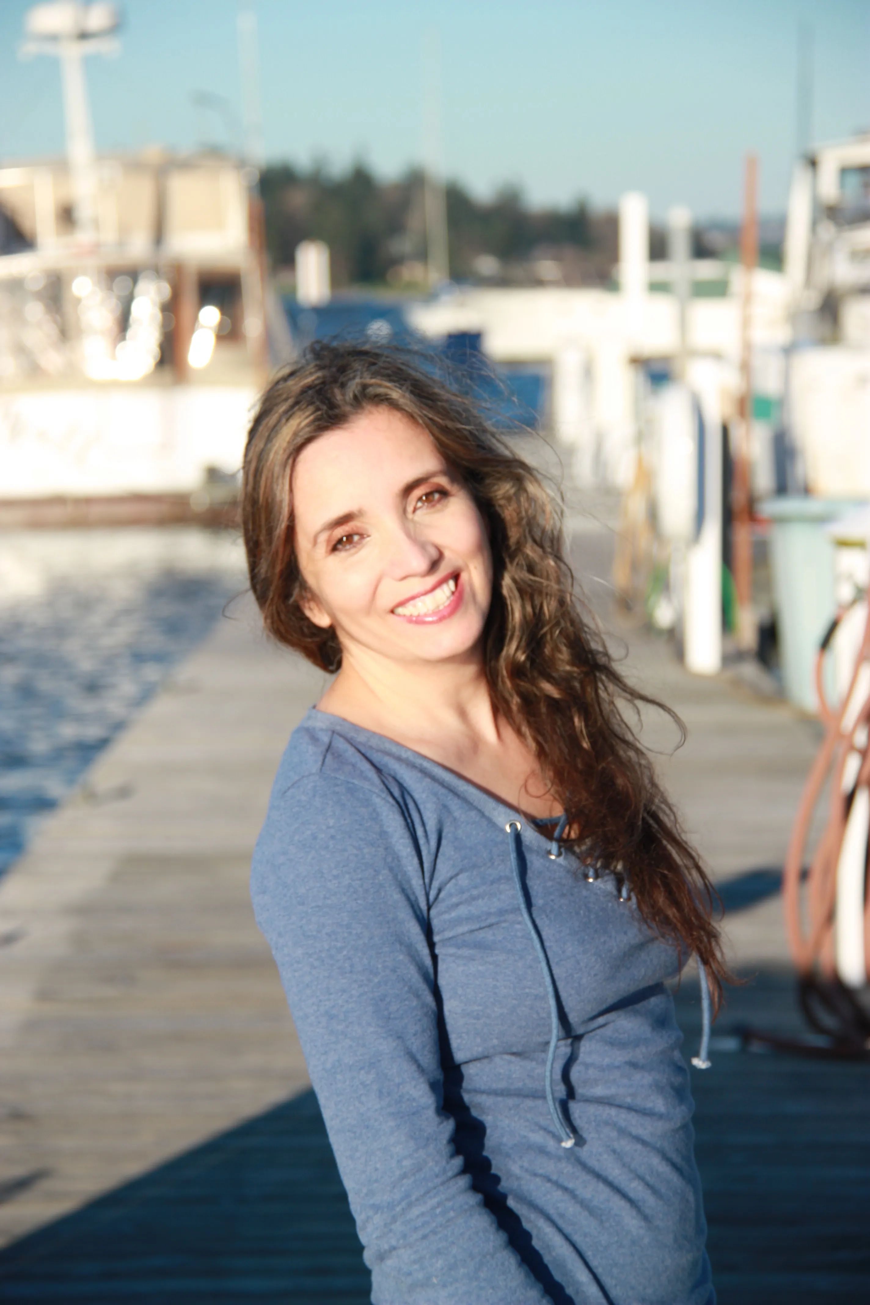 Inelia Benz smiling on a harbour dock